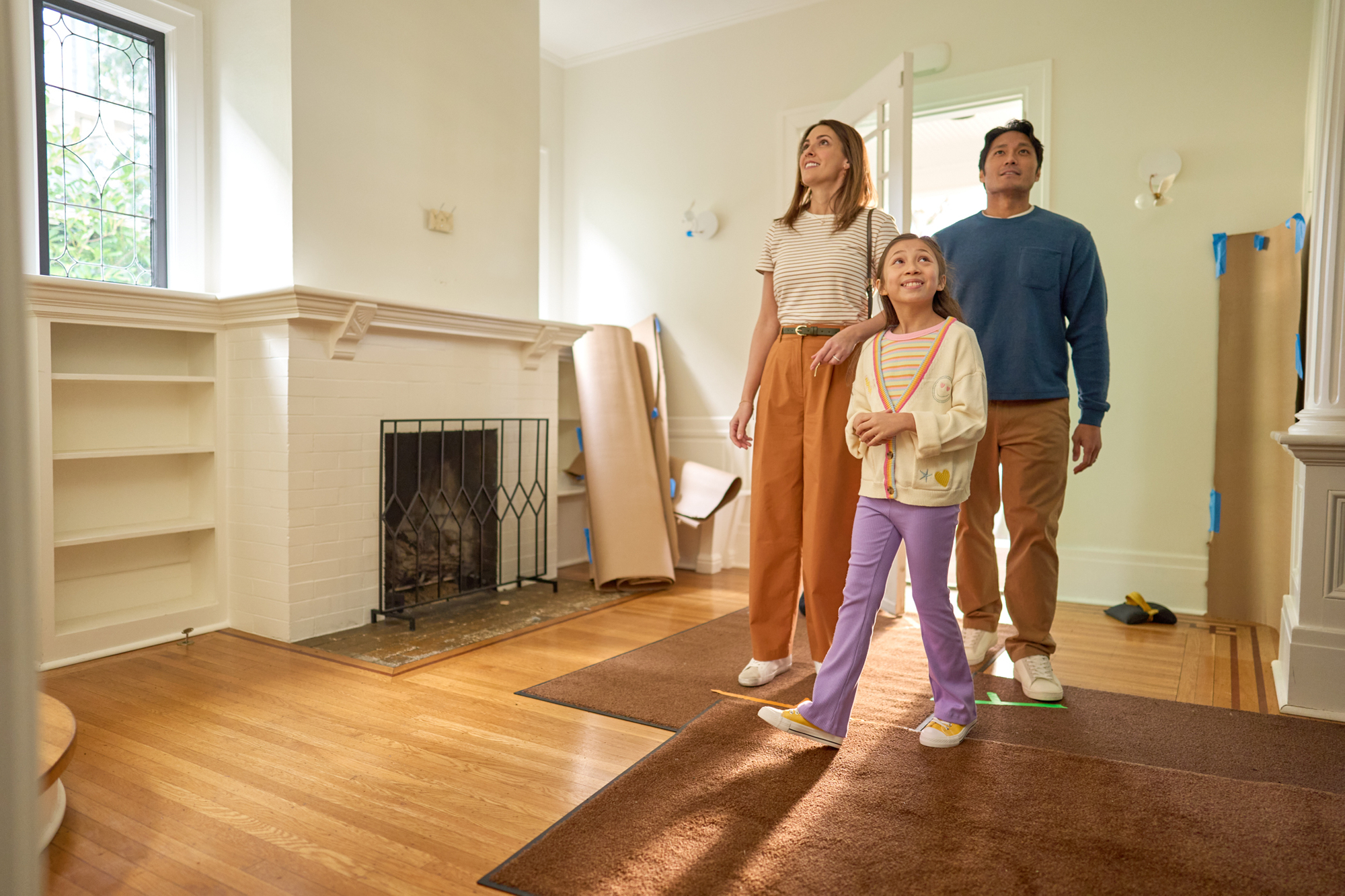 a family with a young daughter walk into their new home thanks to iccu premier visa photographed by troy nebeker New Home