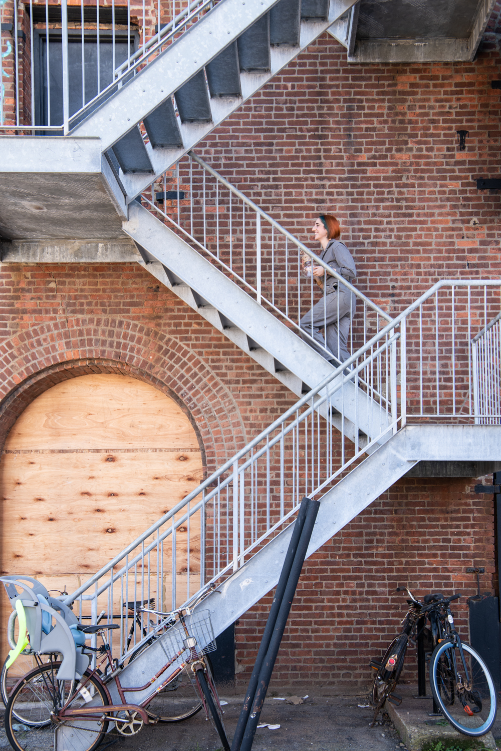 A building with a boarded up walkway that has been reclaimed for artists, working in the city, creative lifestyle shoot Urban environment
