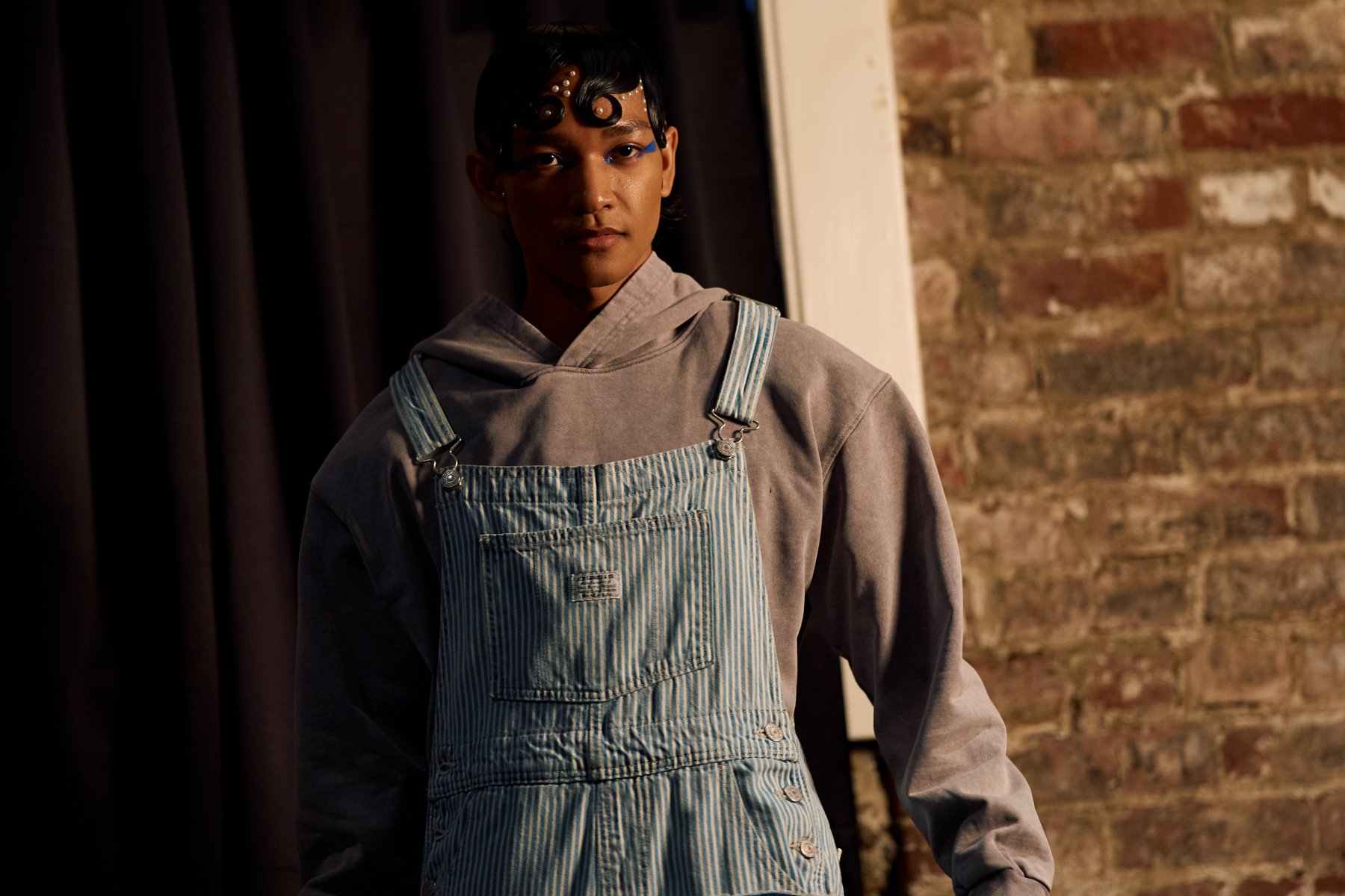 male model in overalls and a hoodie styled by marky mark 