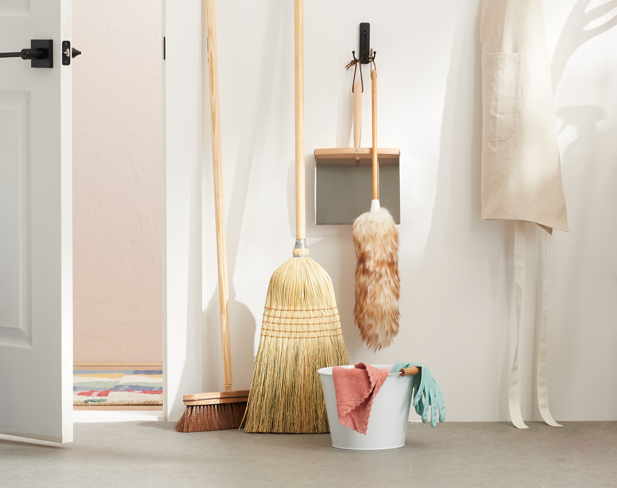 Lovely and immaculate natural cleaning product display styling, creative use of shadow and light interaction, fresh and bright interior spaces Cleaning products behind the white door