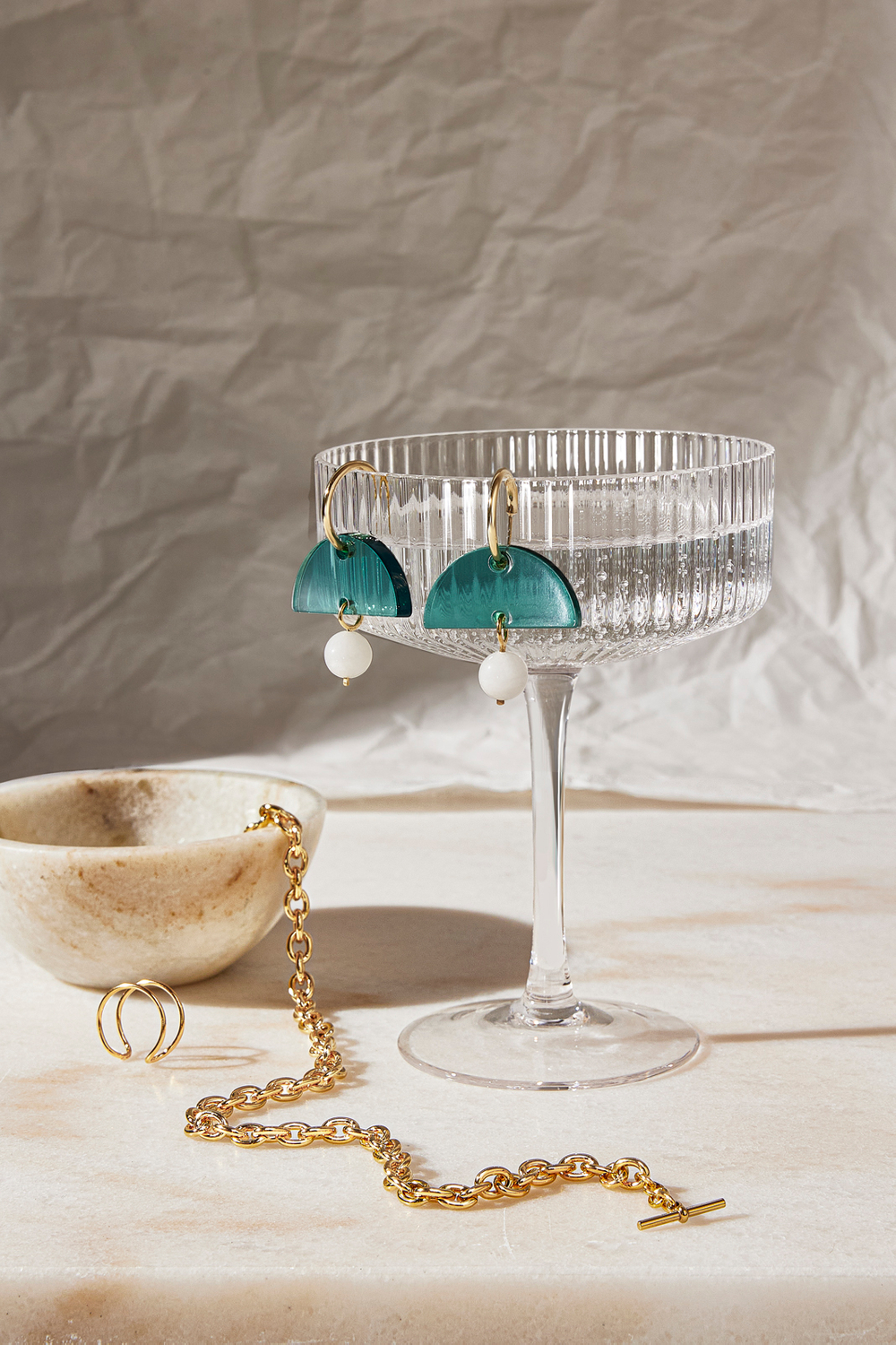 Elegant wearable pieces displayed with earth tones Beautiful prop and jewelry styling