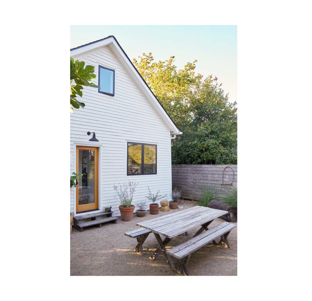 simple clean backyard with picnic table and plants Outdoor Patio