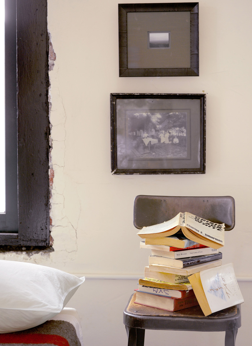 makeshift chair nightstand with books 