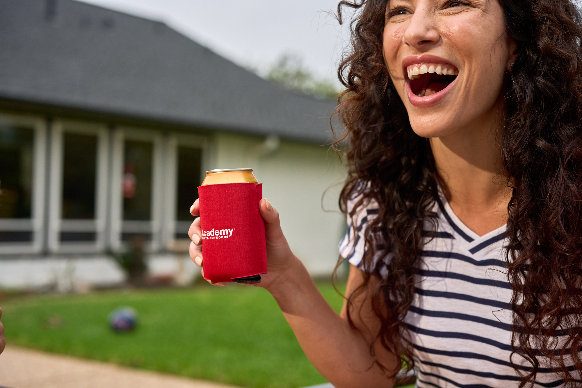 woman enjoys a summer beverage on the patio with academy sports 