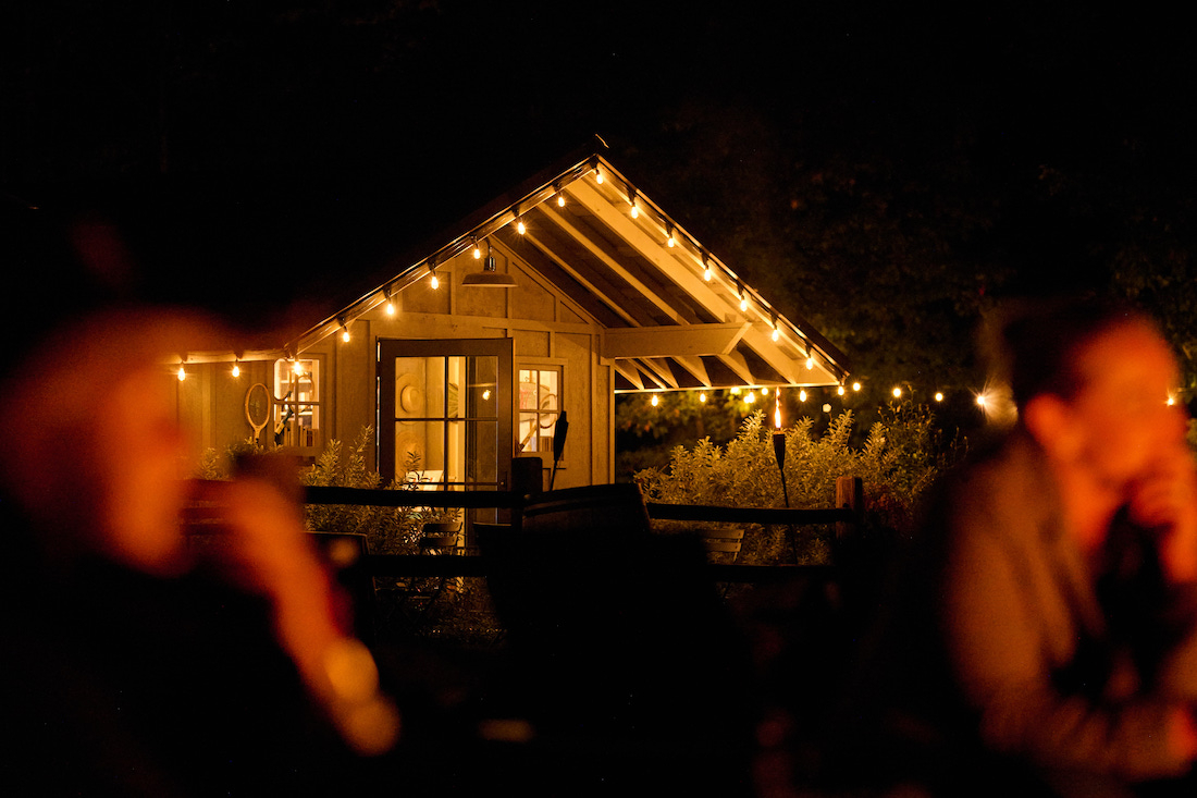 Sarah Flotard - Seattle Based Commercial Lifestyle Food And Beverage Photographer cabin with string lights lit by the campfire glow