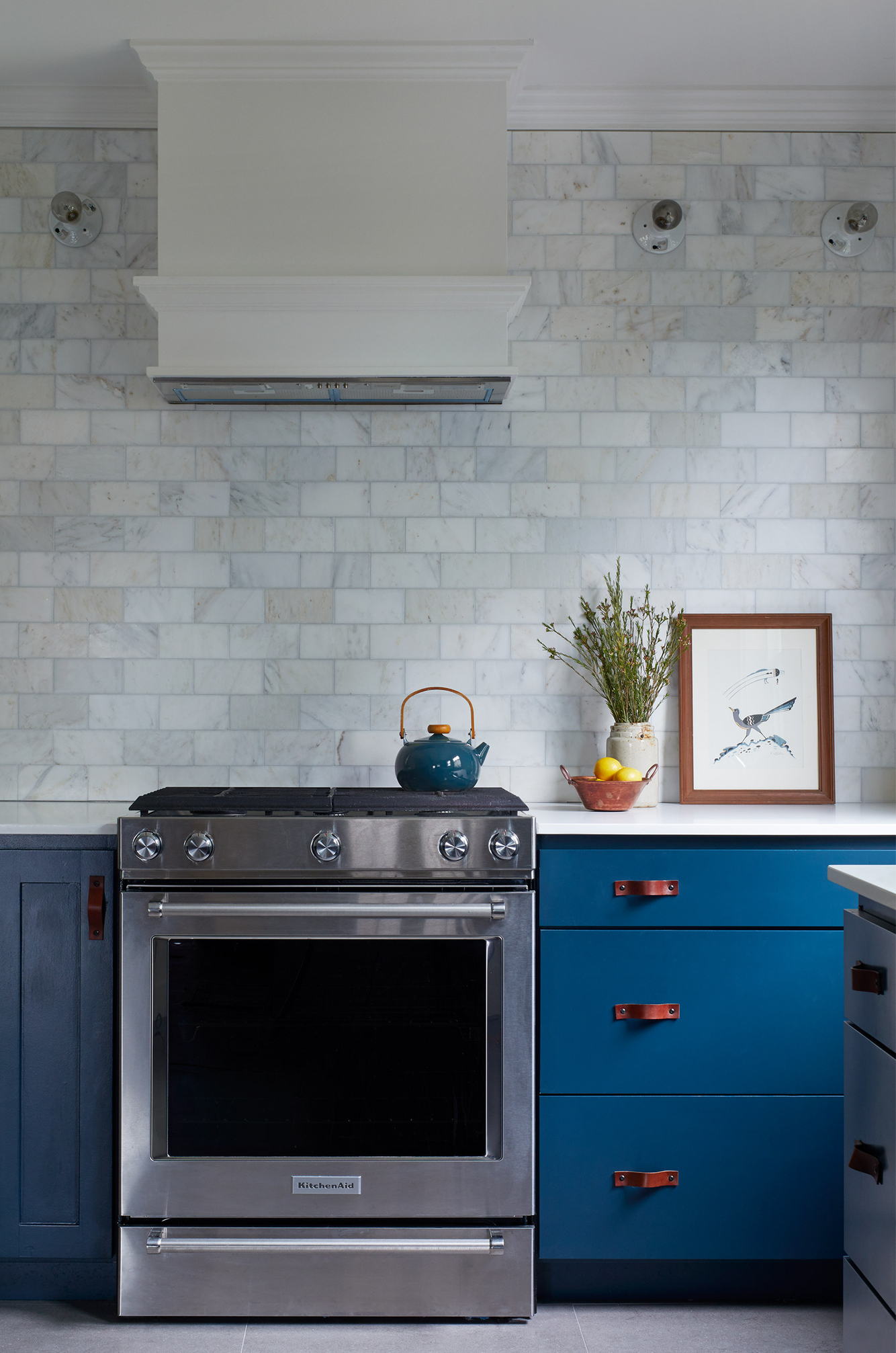 Kitchen with Blue cabinet grey tile blacksplash
