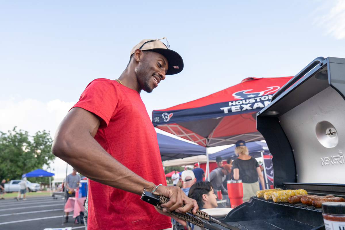 man grills out at a tailgate party