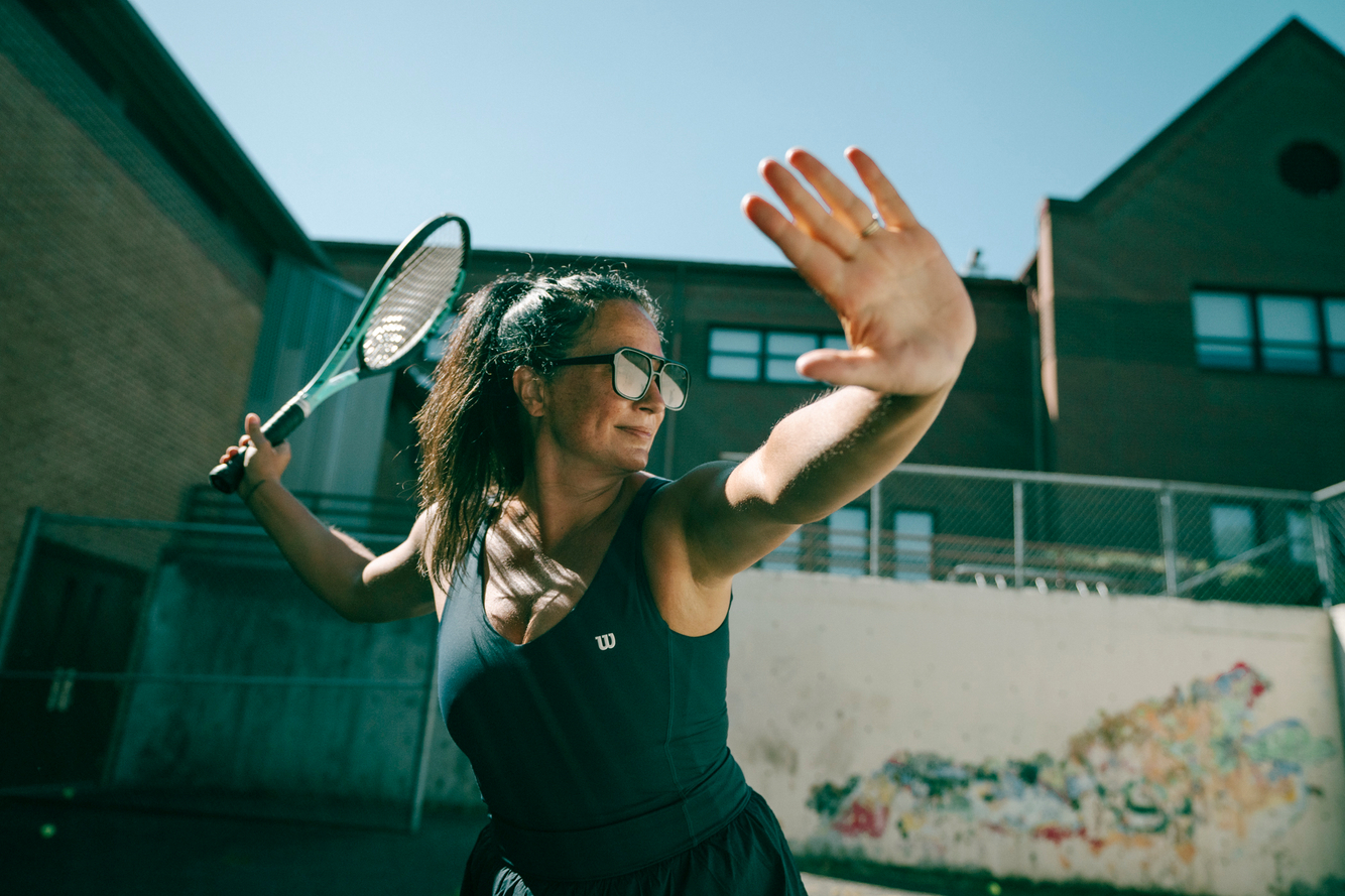 woman gets ready to hit tennis ball Troy Nebeker for wilson tennis