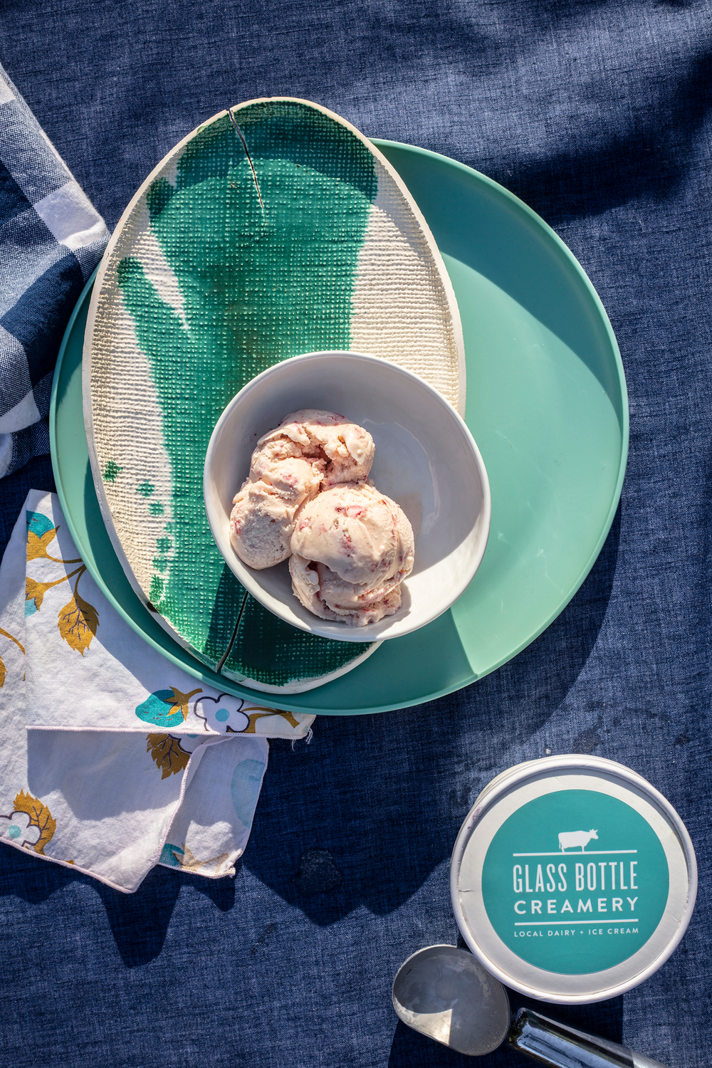 beautiful serving ideas , food styling and photography, dark blue linen tablecloth, vintage napkins, checkered blue hand cloth, adorable strawberry printed cloth napkin Ice cream and mint dishware that matches mint colored product label