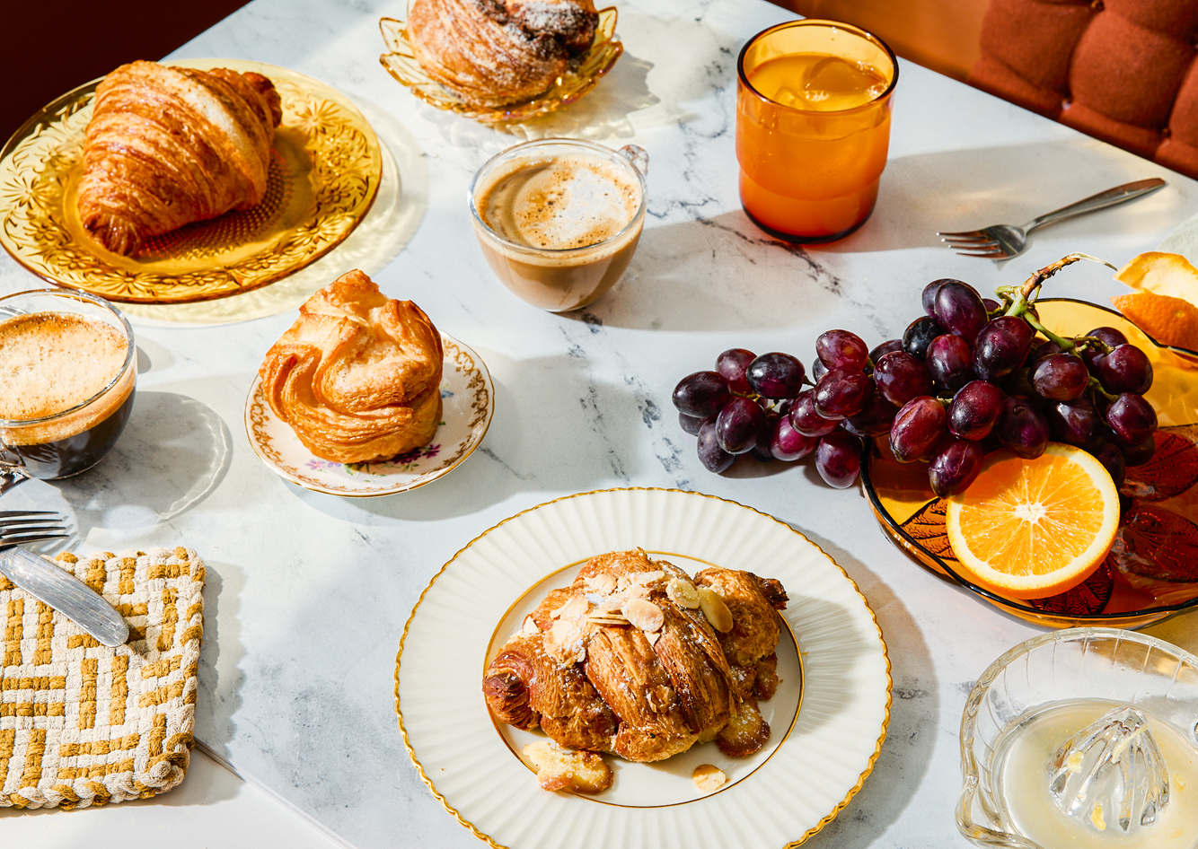 a delicious breakfast spread of pastries, fruit, and coffee 