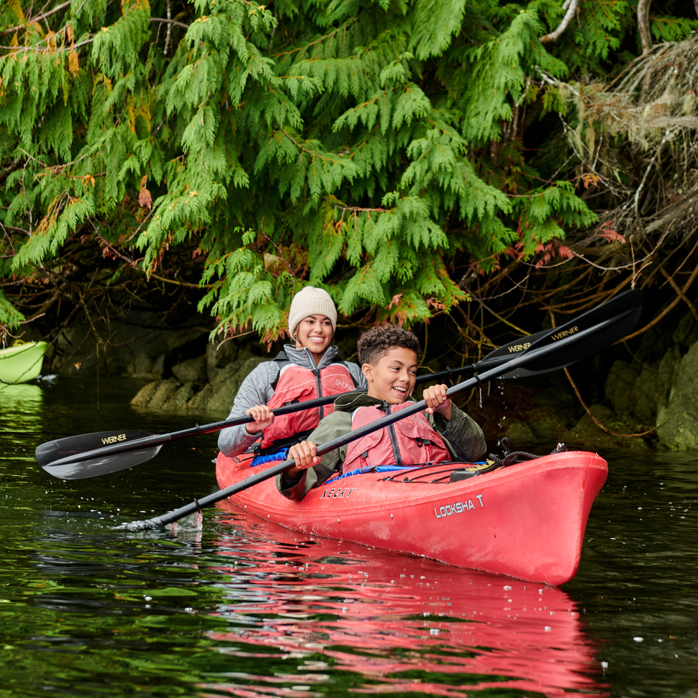 Sister and younger brother kayak together 