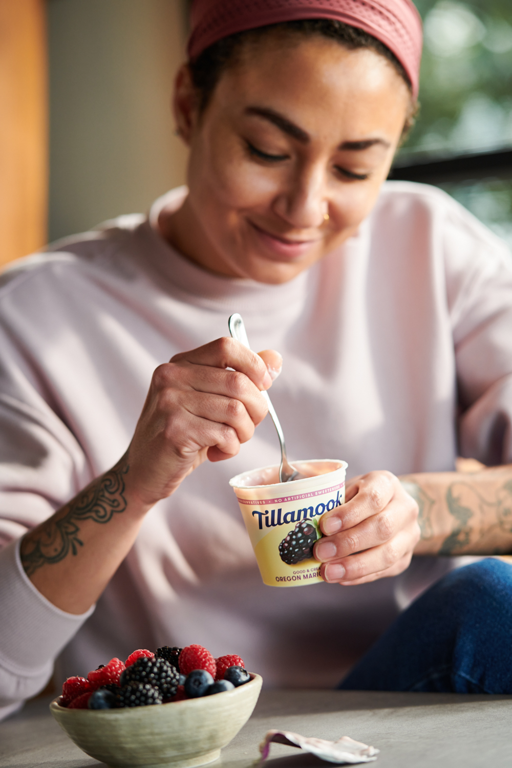 Woman eating Tillamook Blackberry Yogurt