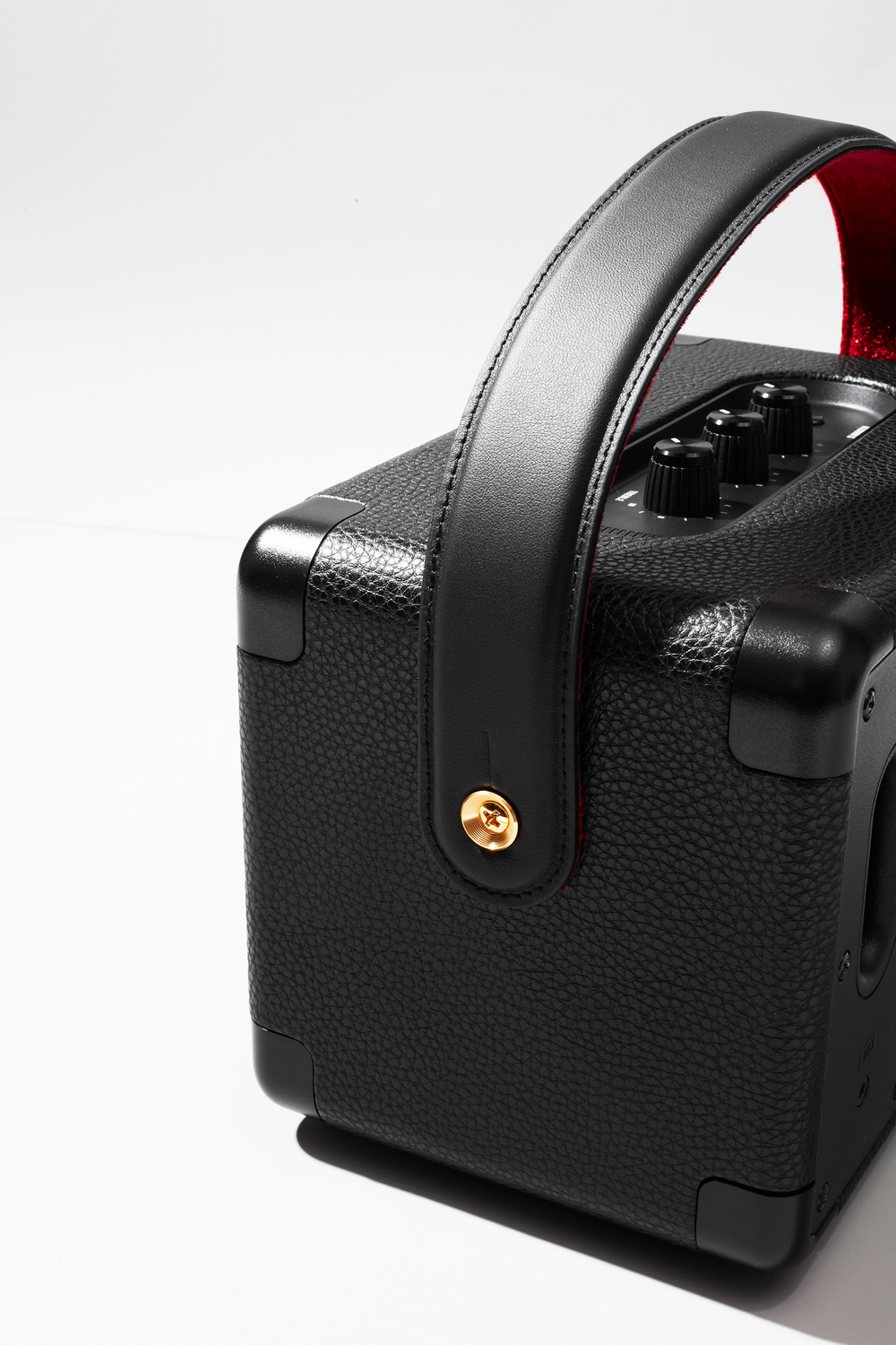 Leather amp handle and textured surface shown in perfect lighting, classic speaker for all your music dreams, loud bass A speaker shown from the side