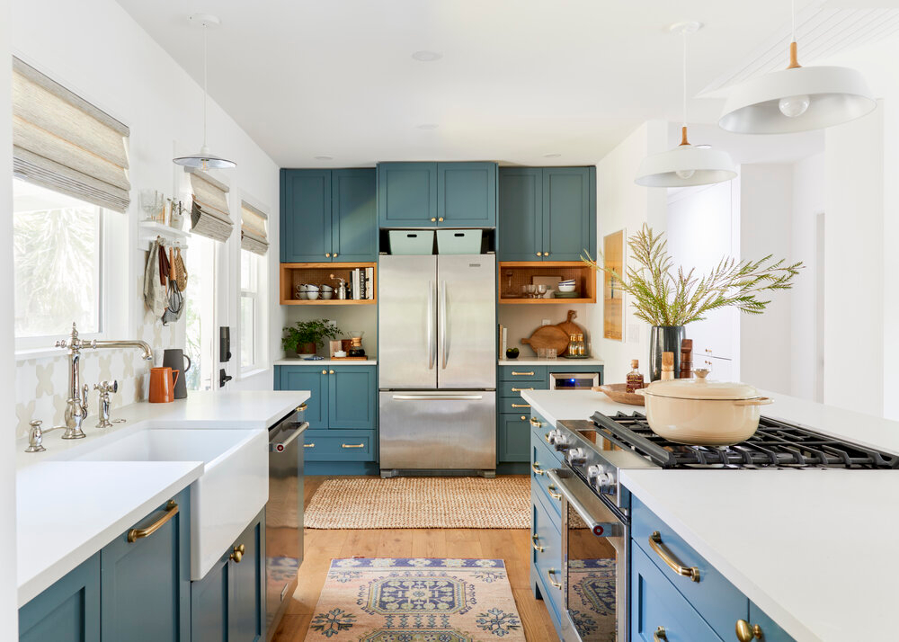 modern kitchen with teal cabinets and gold accents 