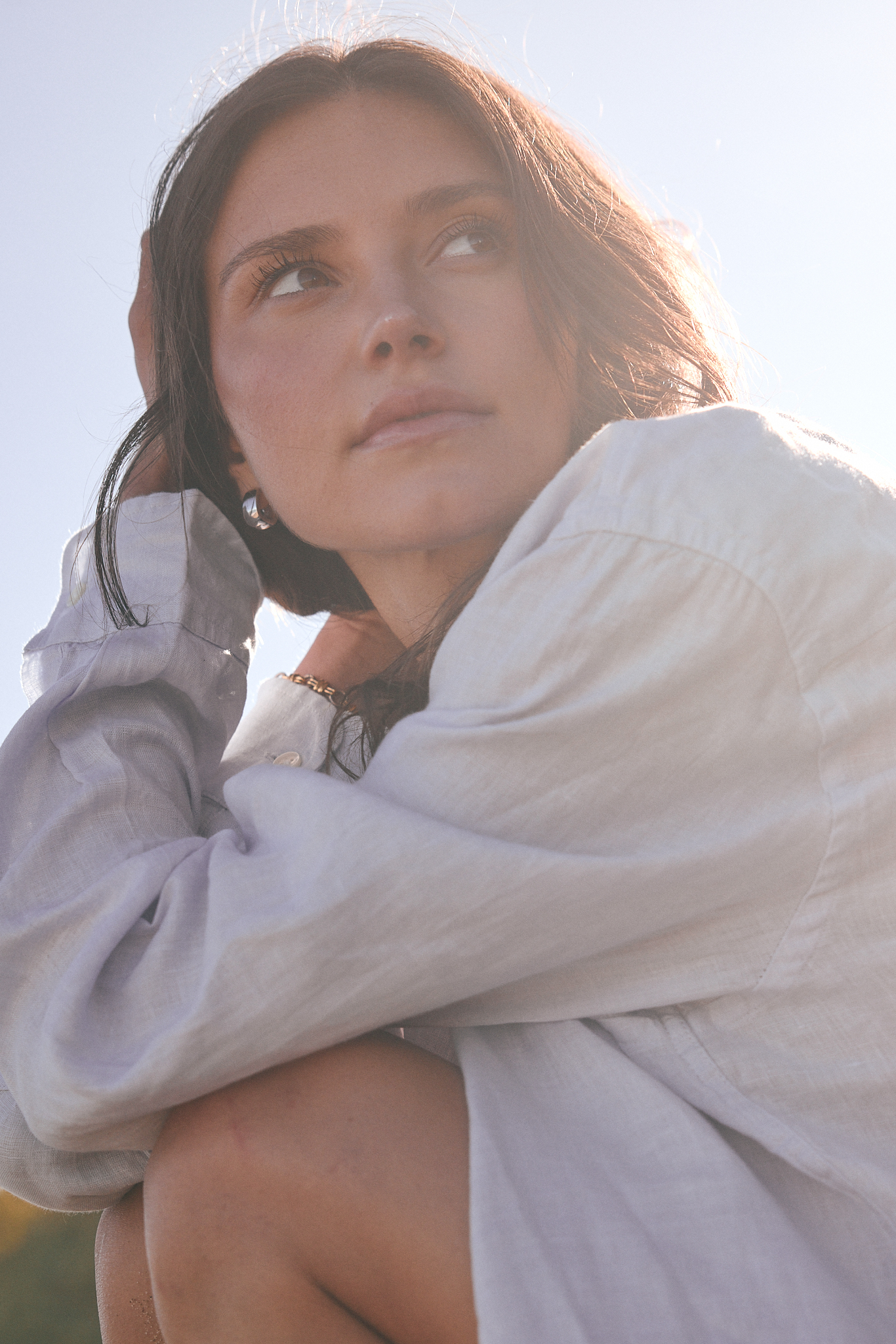 young brunette woman in white button down 