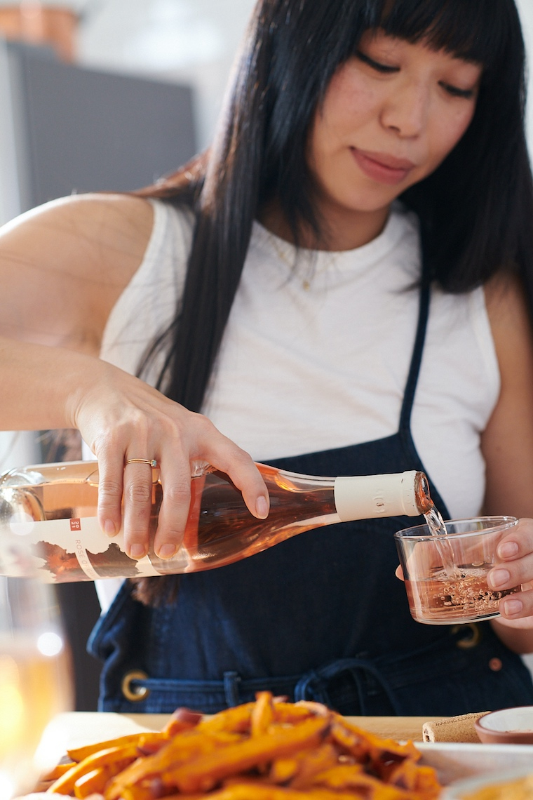 Woman pours rose wine