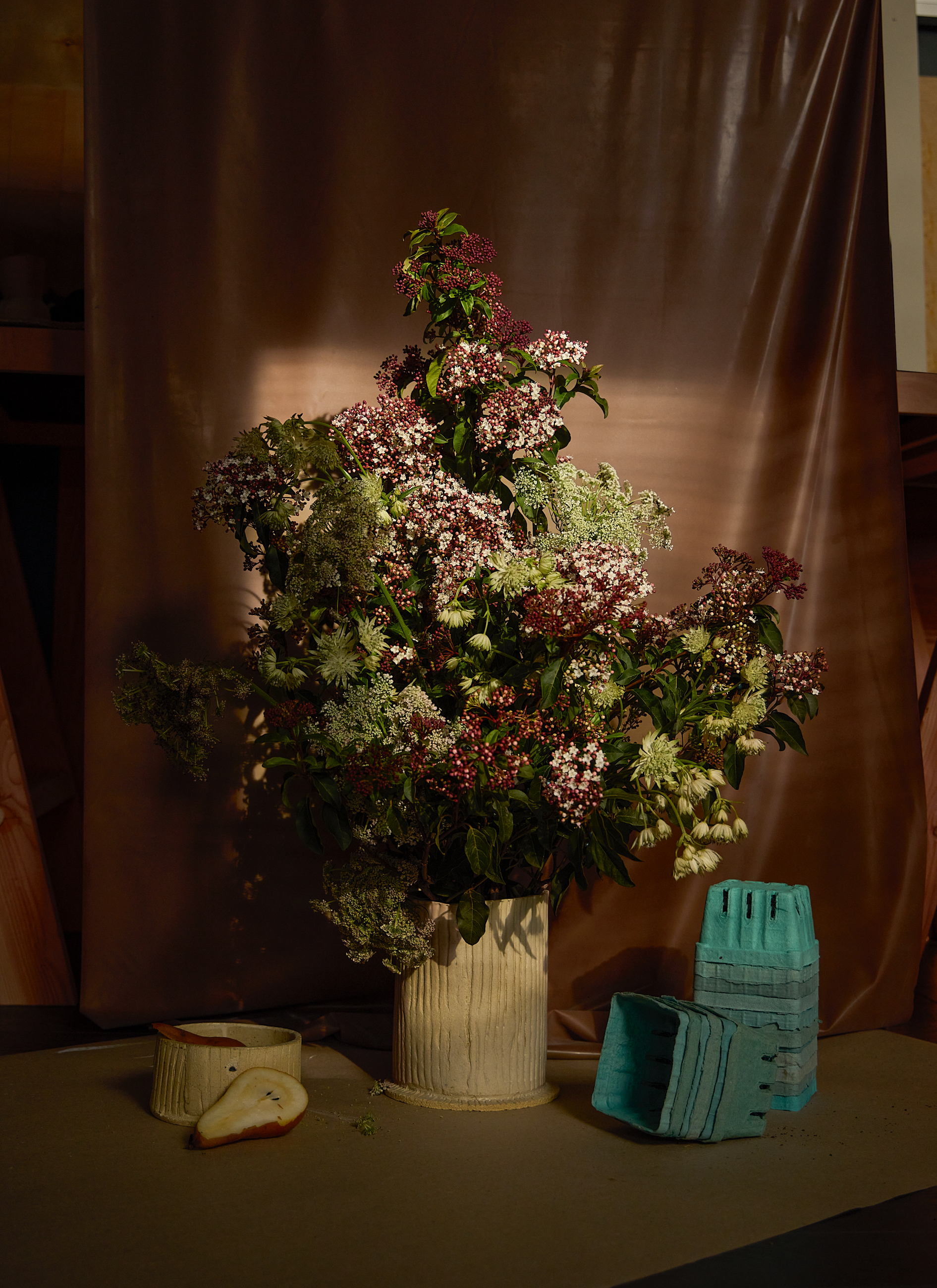 floral arrangement overflows from textured vase Good Connections