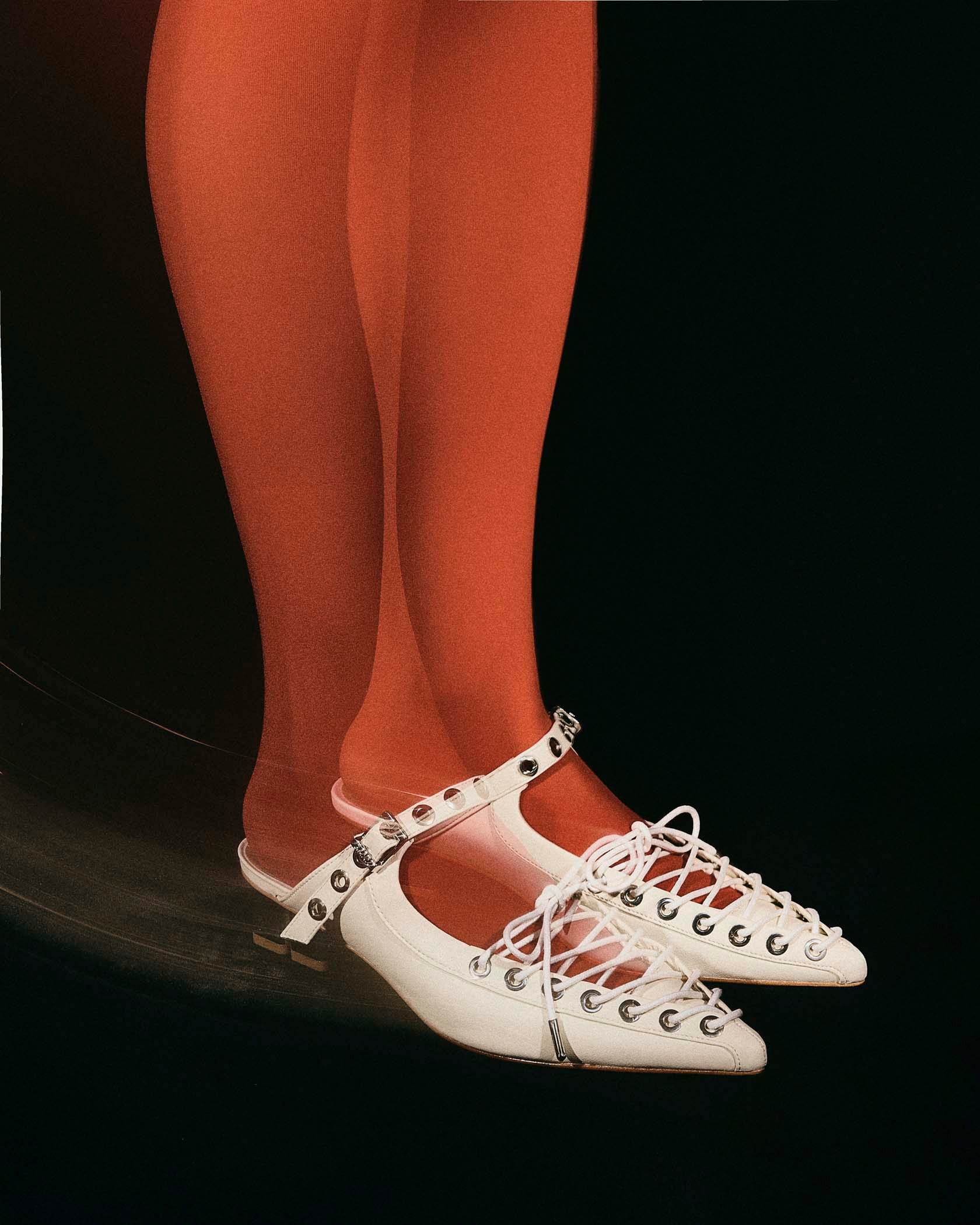 woman in red stockings wears off white pointed toe lace up ganni shoes photographed by commercial seattle based photographer Alison Blomgren Alison Blomgren for Ganni Shoes