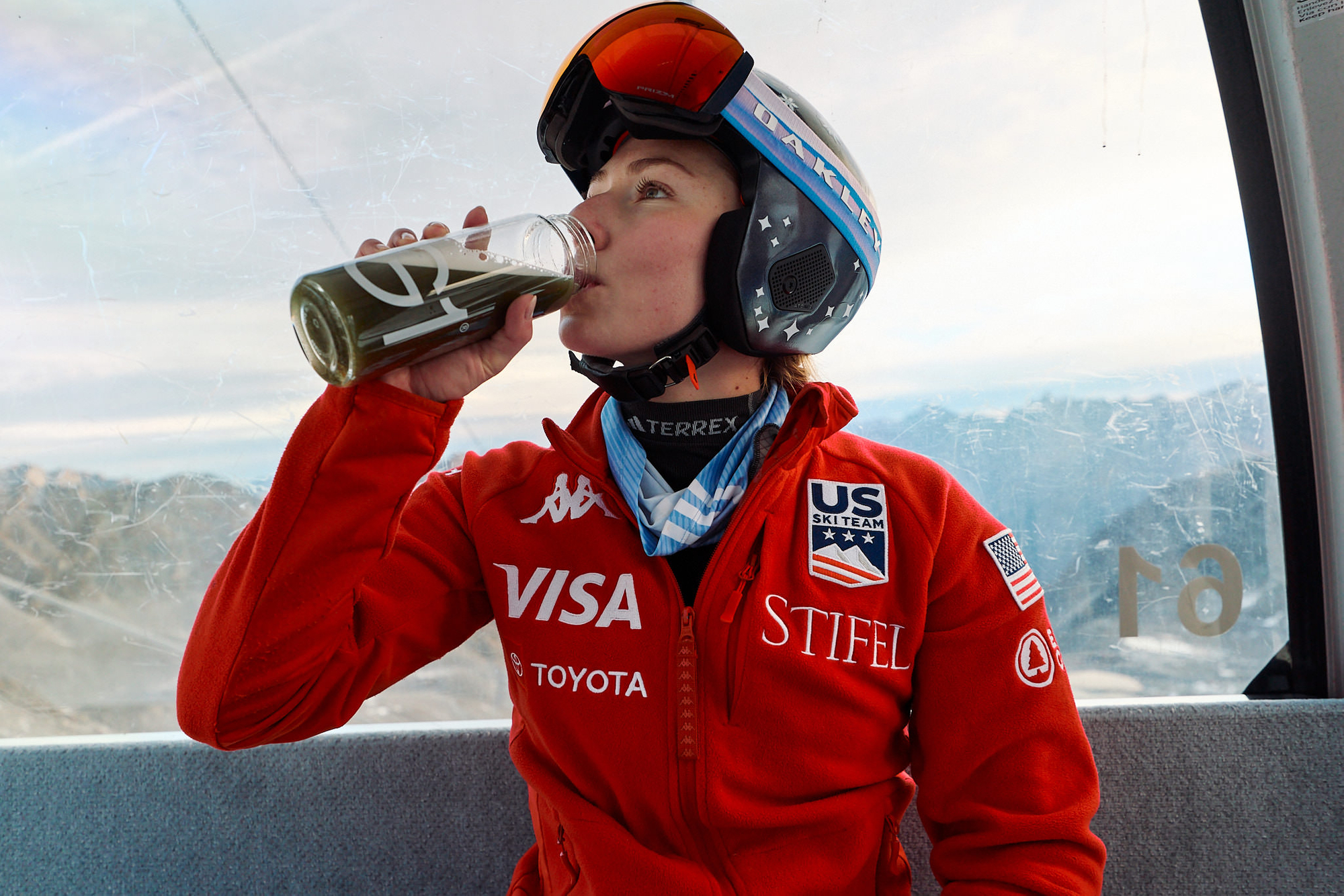 mikaela shiffrin drinks from AG1 on a skii lift 