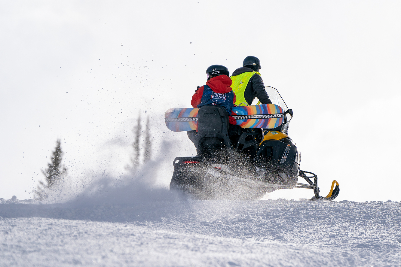 Troy Nebeker photographs snowboarders on a snow bike snow bike