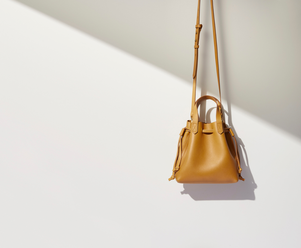 Luxury handbag product photography Mustard bucket bag