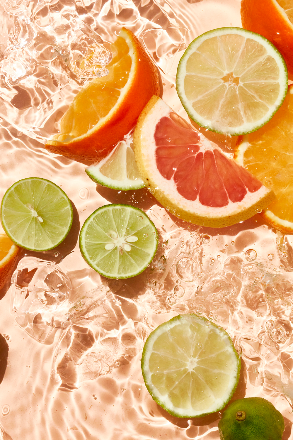 Bright and pastel oranges, cold refreshing drinks, summer beverage ideas, fresh fruit styling Dappled light in the water