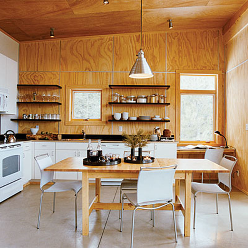 wood paneled wall kitchen with white cabinets 