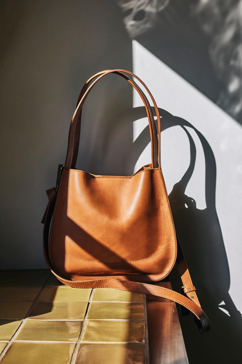Designer purse in a kitchen in the natural light. Beautiful light and shadows