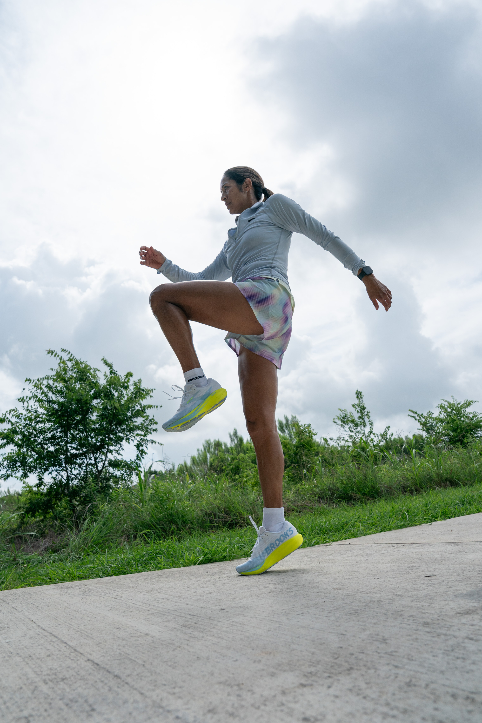 female runner stretches before a run