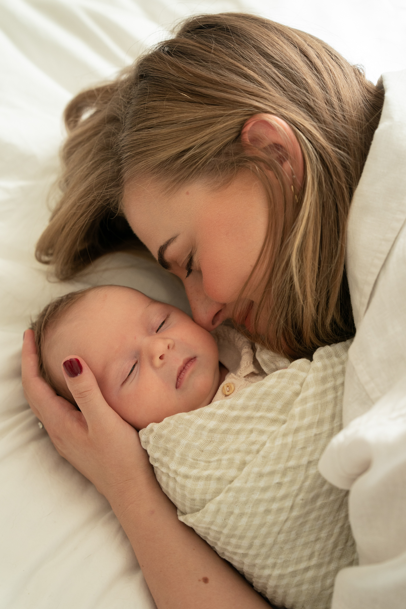 mom cuddles her baby 