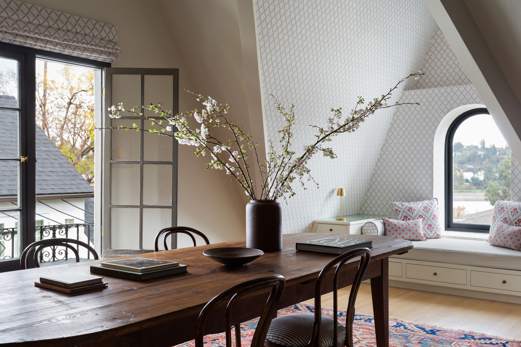 gorgeous dining room with window nook and long wooden dining table 