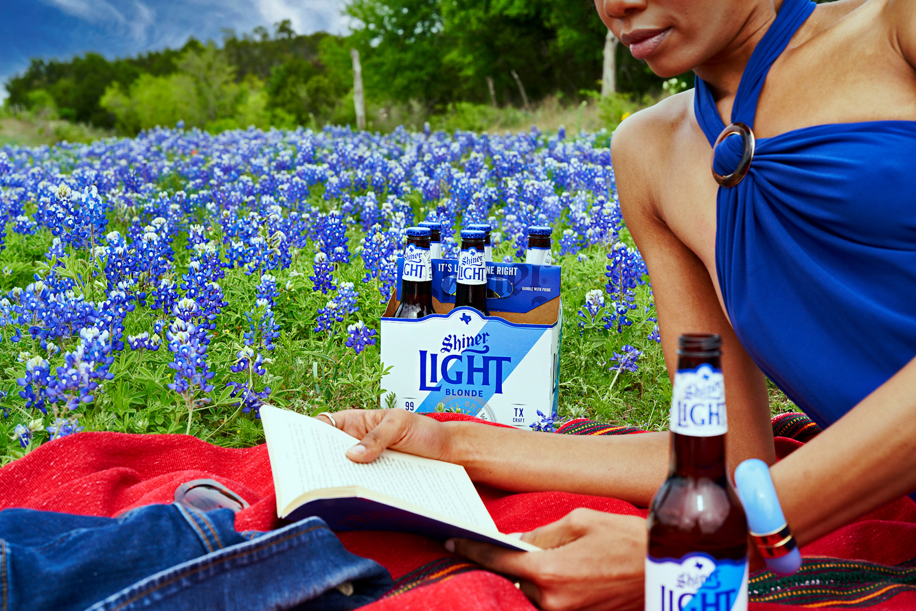 Shiner-Blonde-with-Beautiful-_Black_Woman_on_Picnic-Blanket_In-Flower-Field_Spring_by-Knoxy-Knox_Beer_Book_Reading_KXY04441.jpg