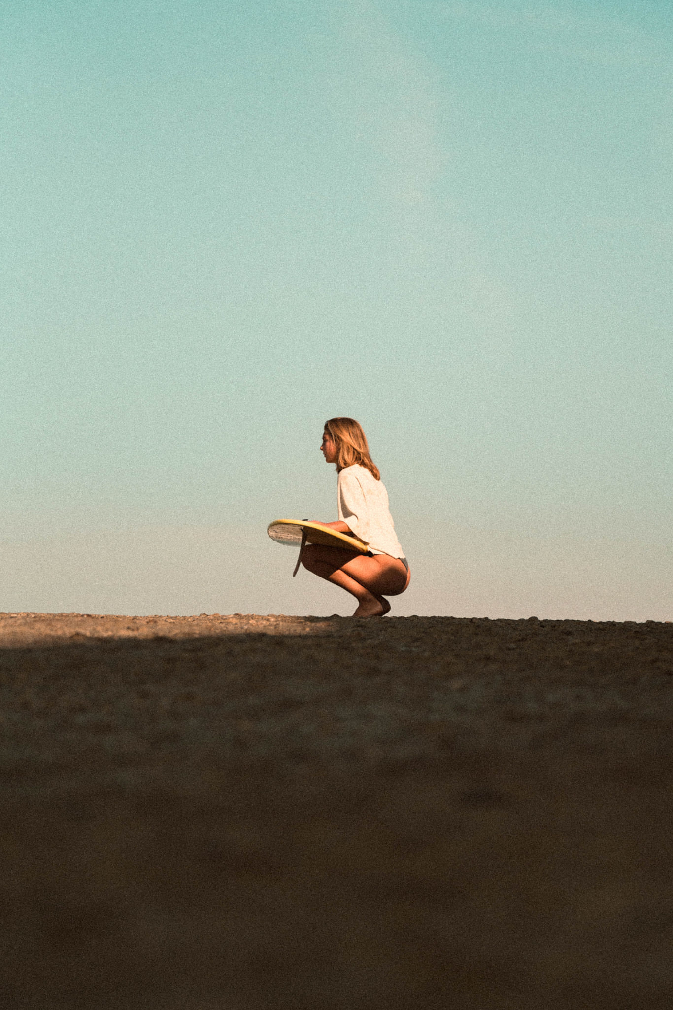 young blonde girl with surfboard 