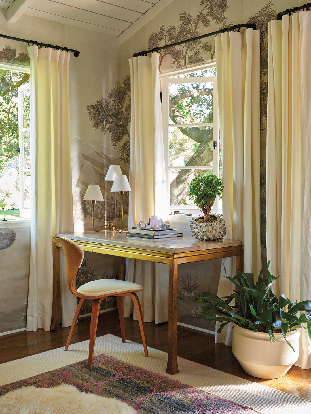 romantic desk with mural wallpaper and plants 