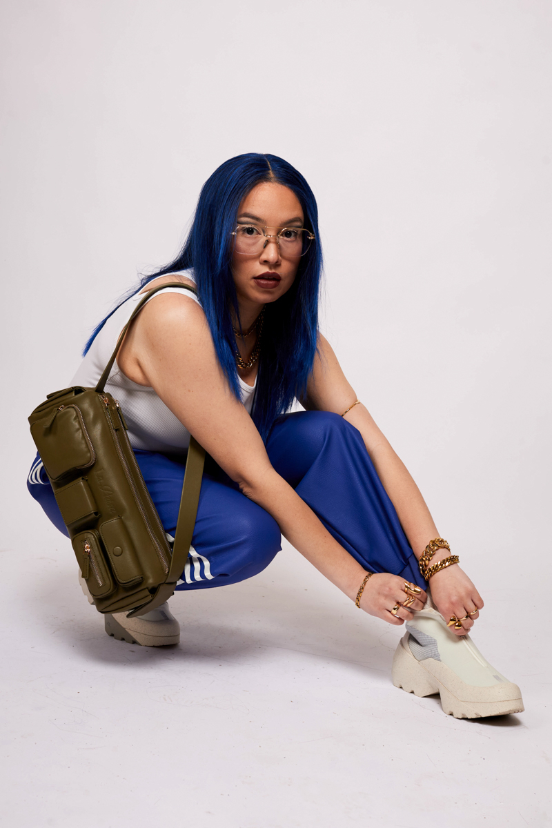 blue haired gen z girl with street style accessories 