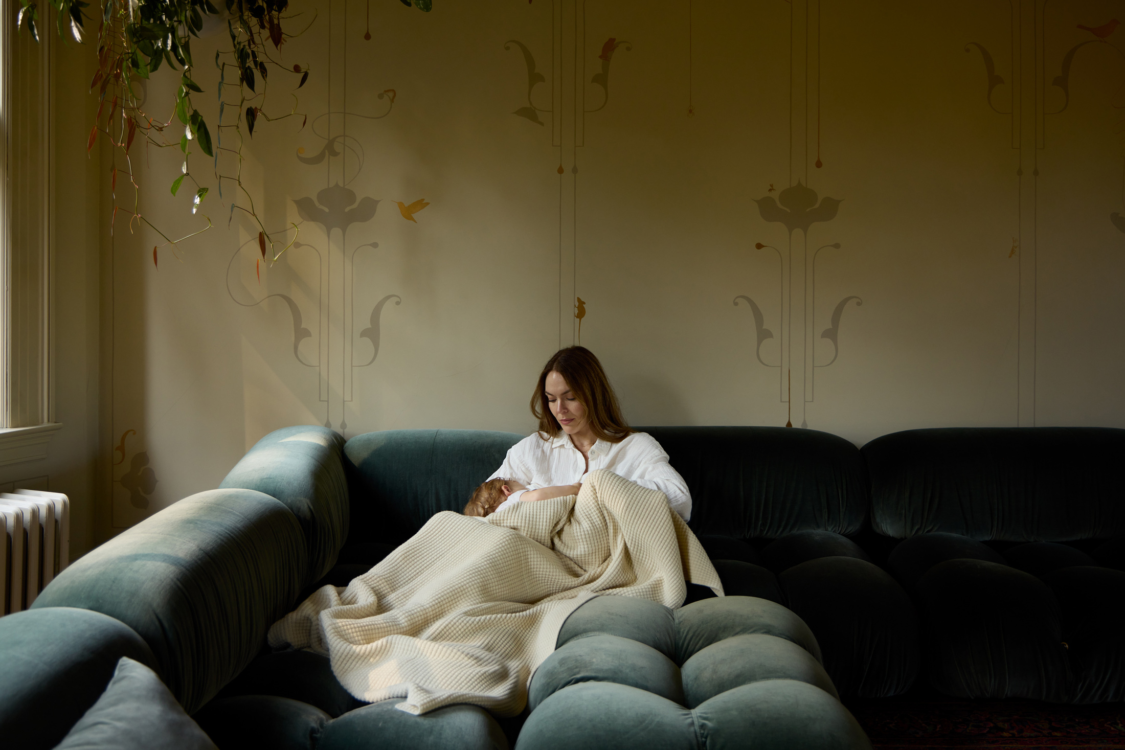 High end living room, interior photographer Portland Oregon, Mother feeding infant