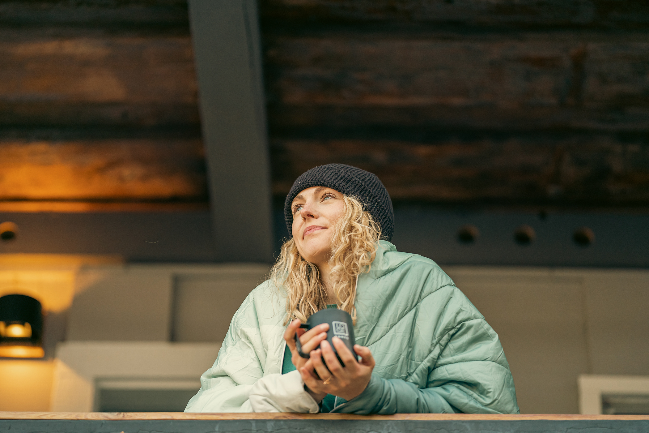 At the cabin, sipping coffee Beanie and down jacket