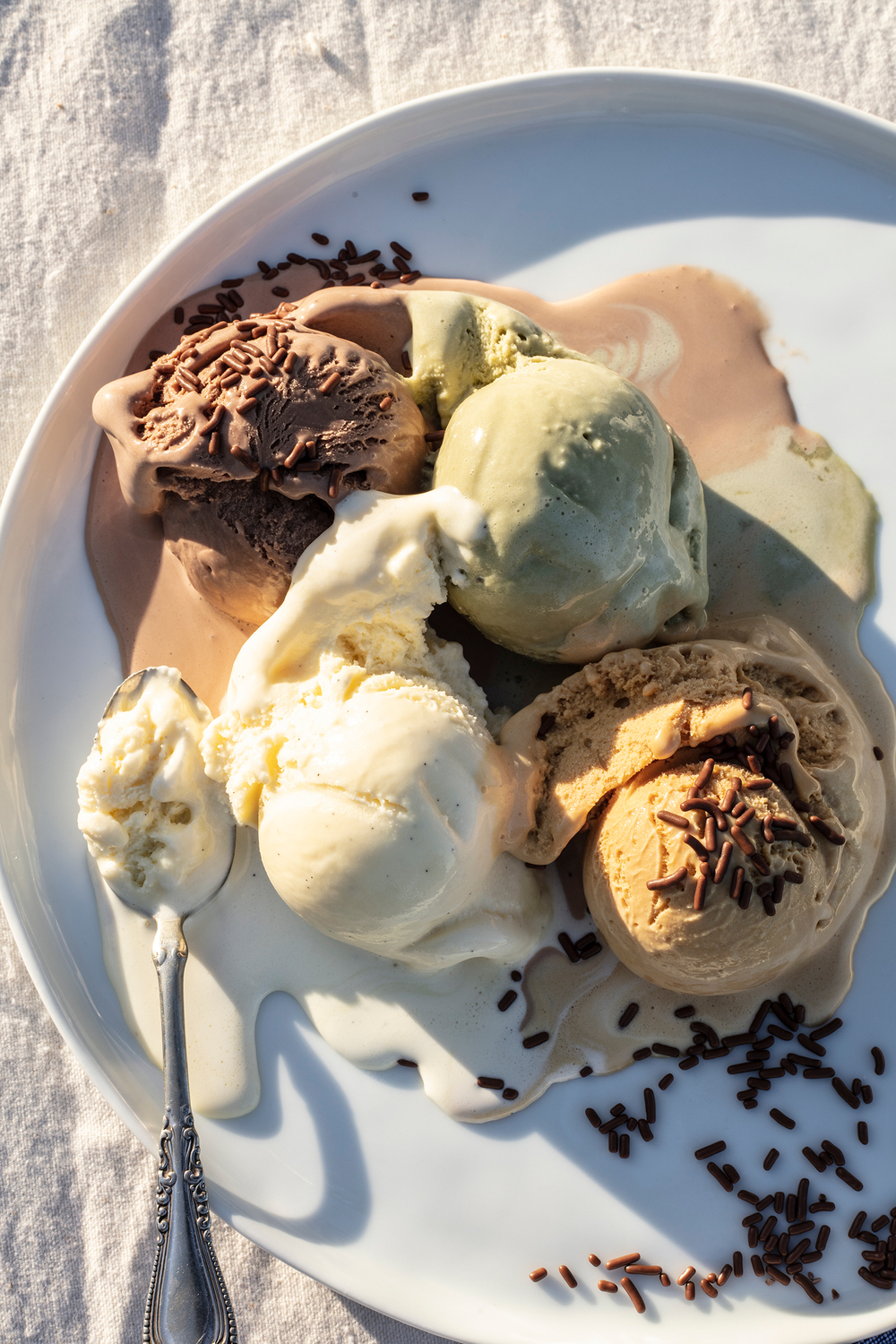 Dessert at golden hour, top Seattle food photographer, beautiful warm lighting Pistachio, salted caramel, vanilla and chocolate
