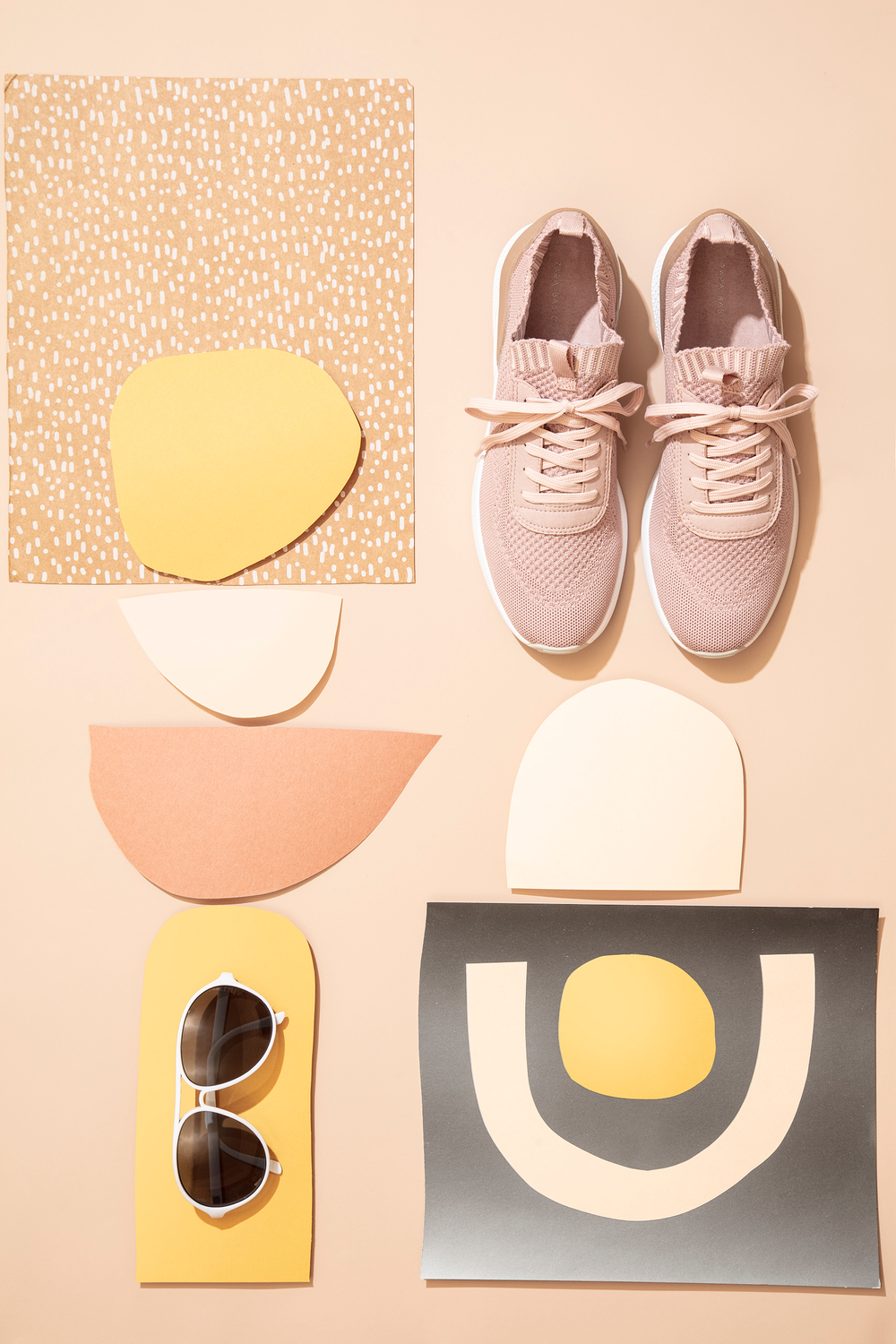 Fashion and still life styling ideas, shapes inspired by nature arranged with sunglasses and shoes, monochromatic color scheme, peaceful pastels Geometric rainbows fashion layout