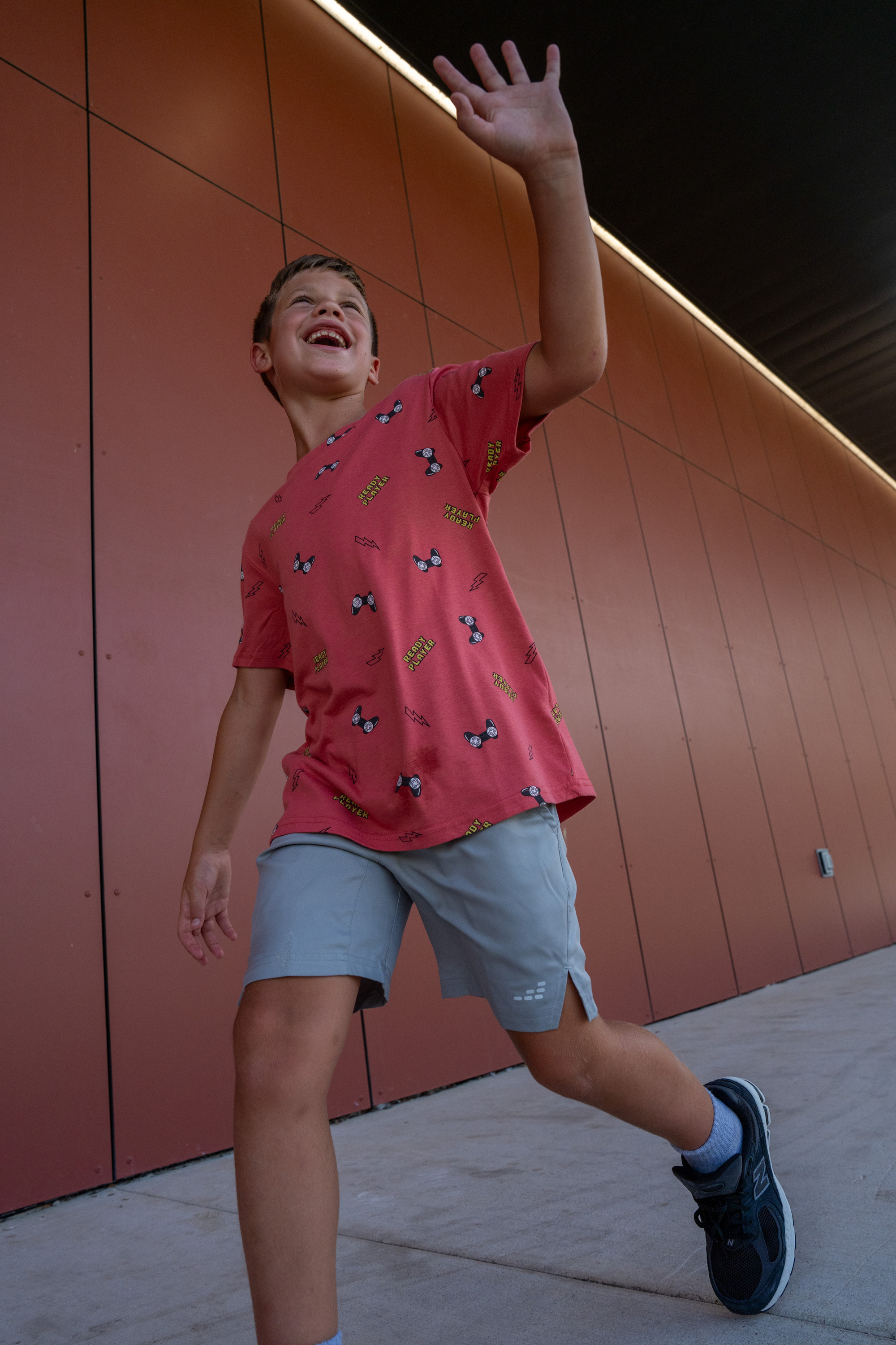 young boy runs through the school halls 