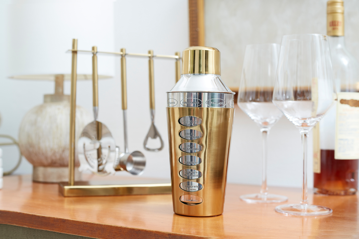 Wine glasses, brown liquor, a mirror above the cocktail station Barware in the home, ideas for creating a drink station