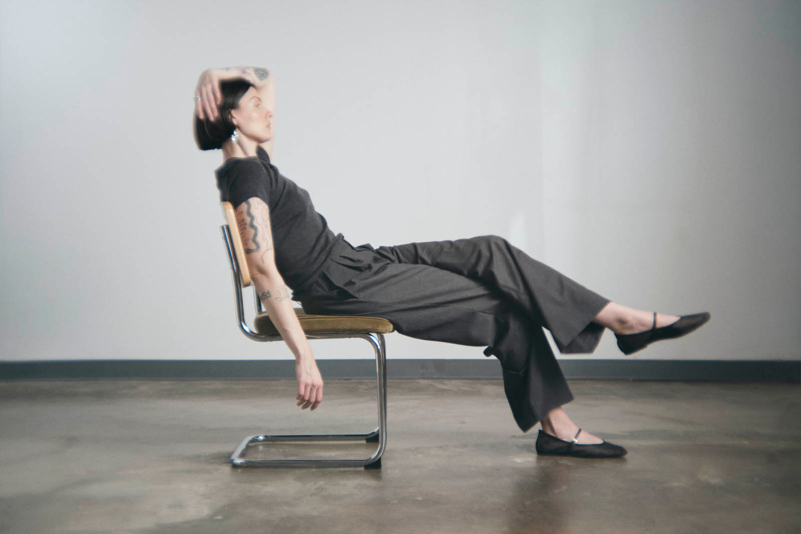 woman lounges in green chair 