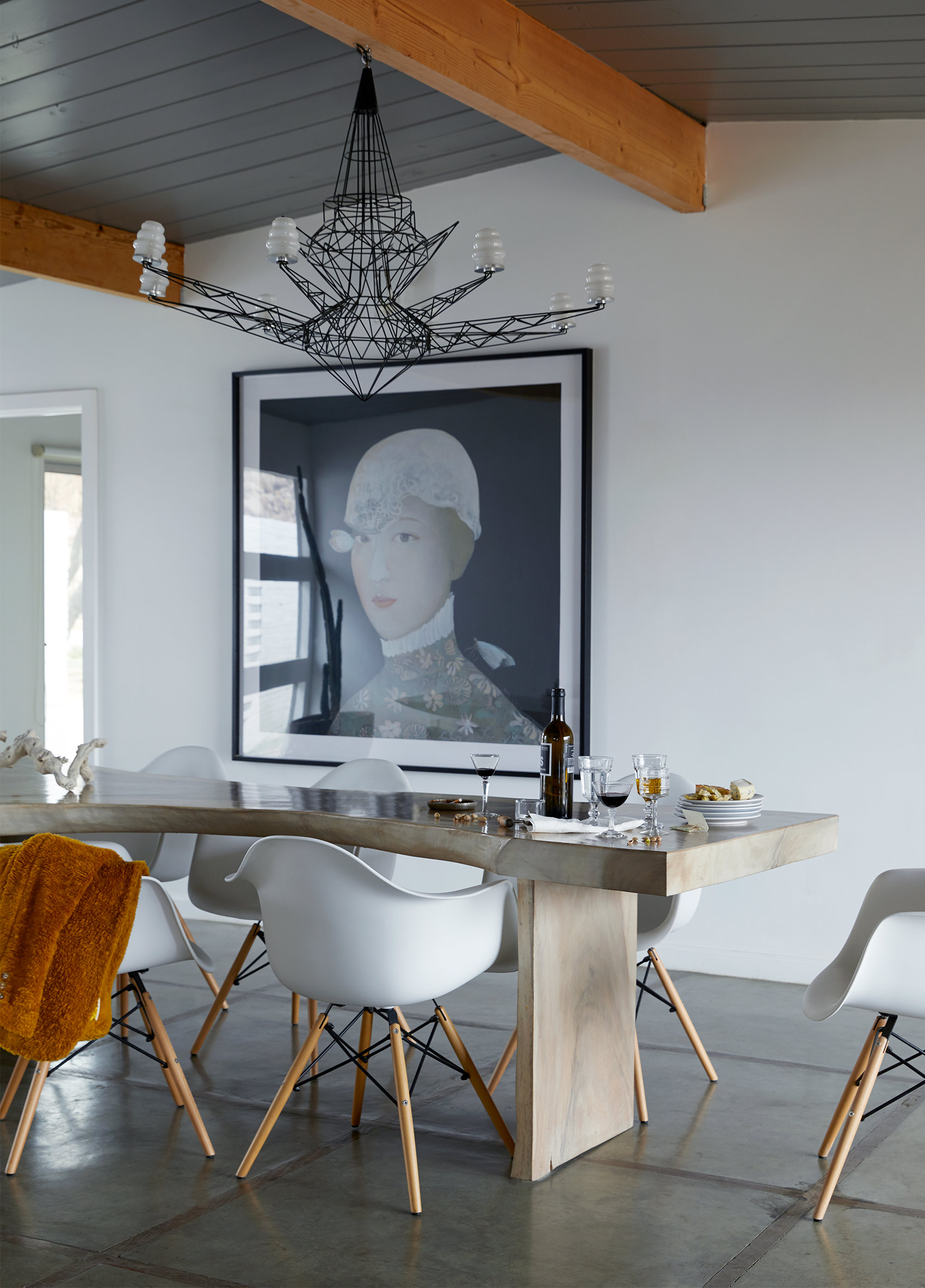 Charles and Ray Eames chairs, architectural elements adorn dining area featured by interior photographer George Barberis Modern dining table, grand portrait