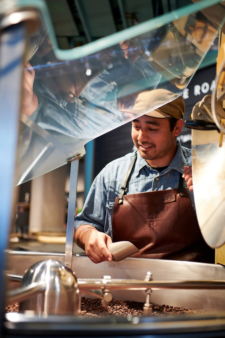 Worker roasting coffee beans