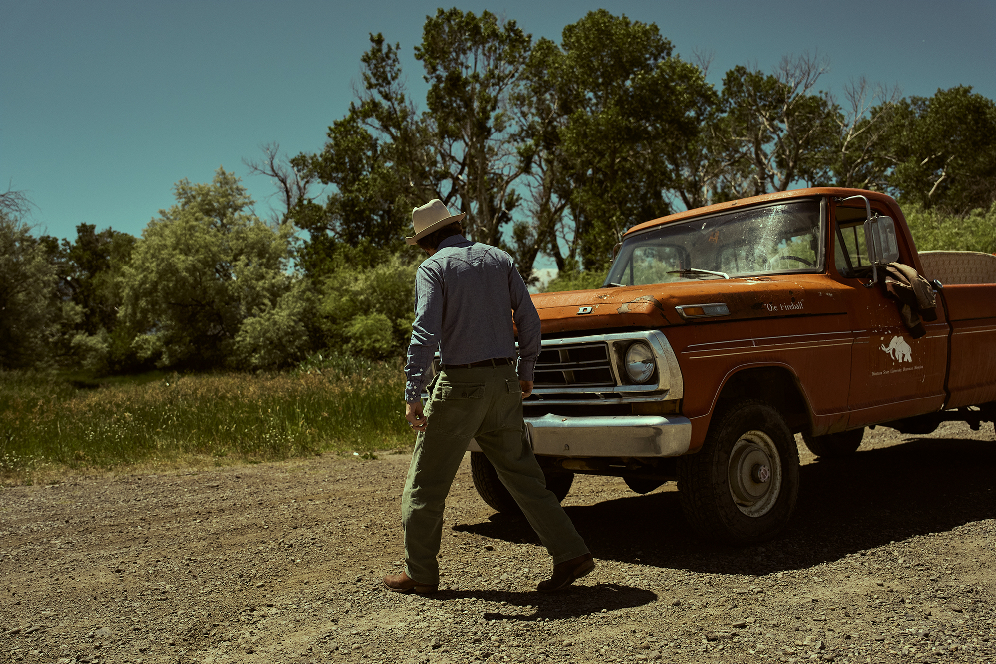 man fixes up his vintage broken down truck 