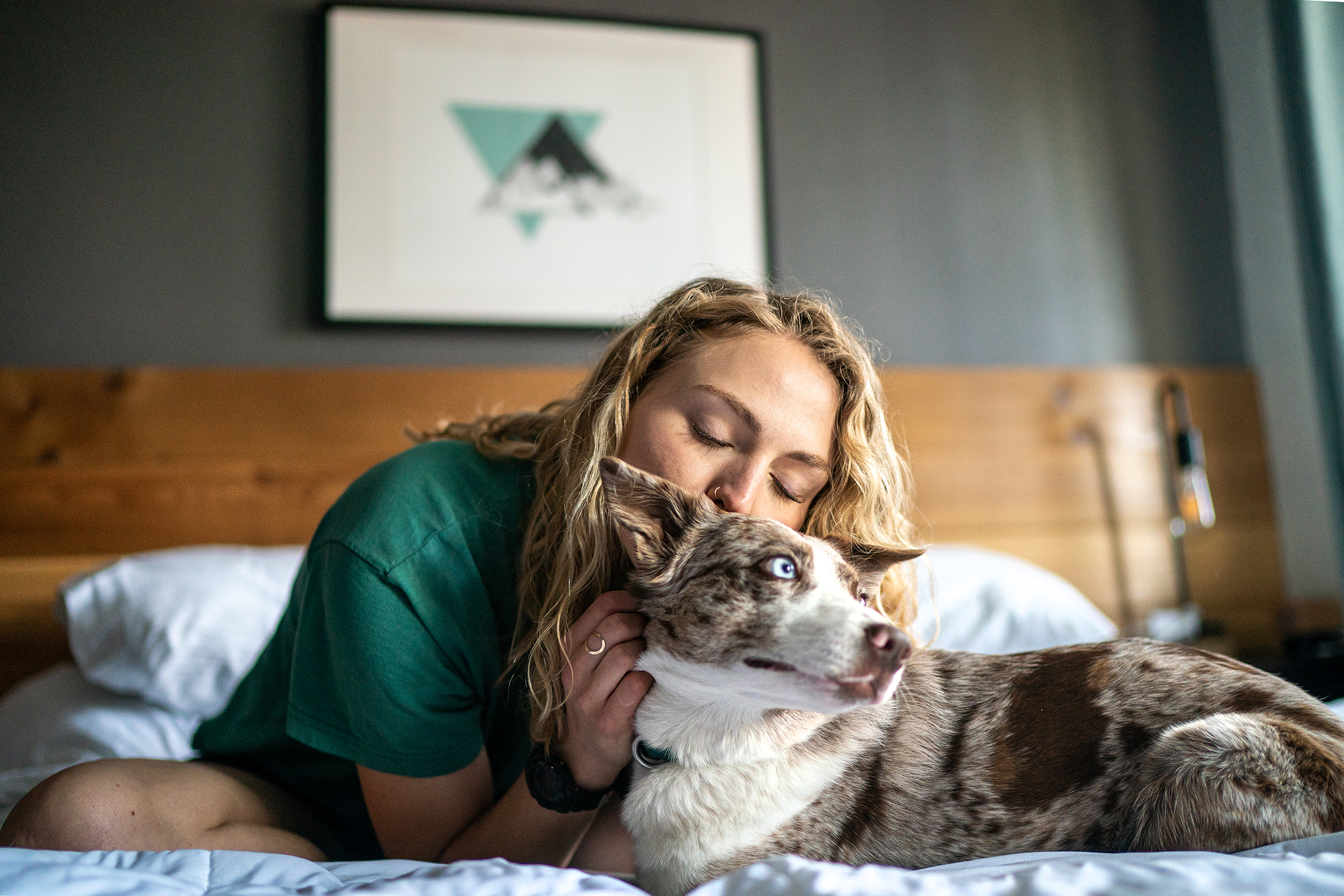 Pet lifestyle, wavy blonde haired gal Blue eyed puppy