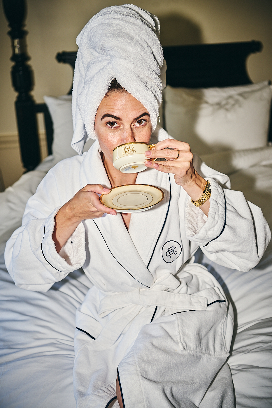 mark humphreys and sarah flotard  woman in white plush robe sipping tea after a shower