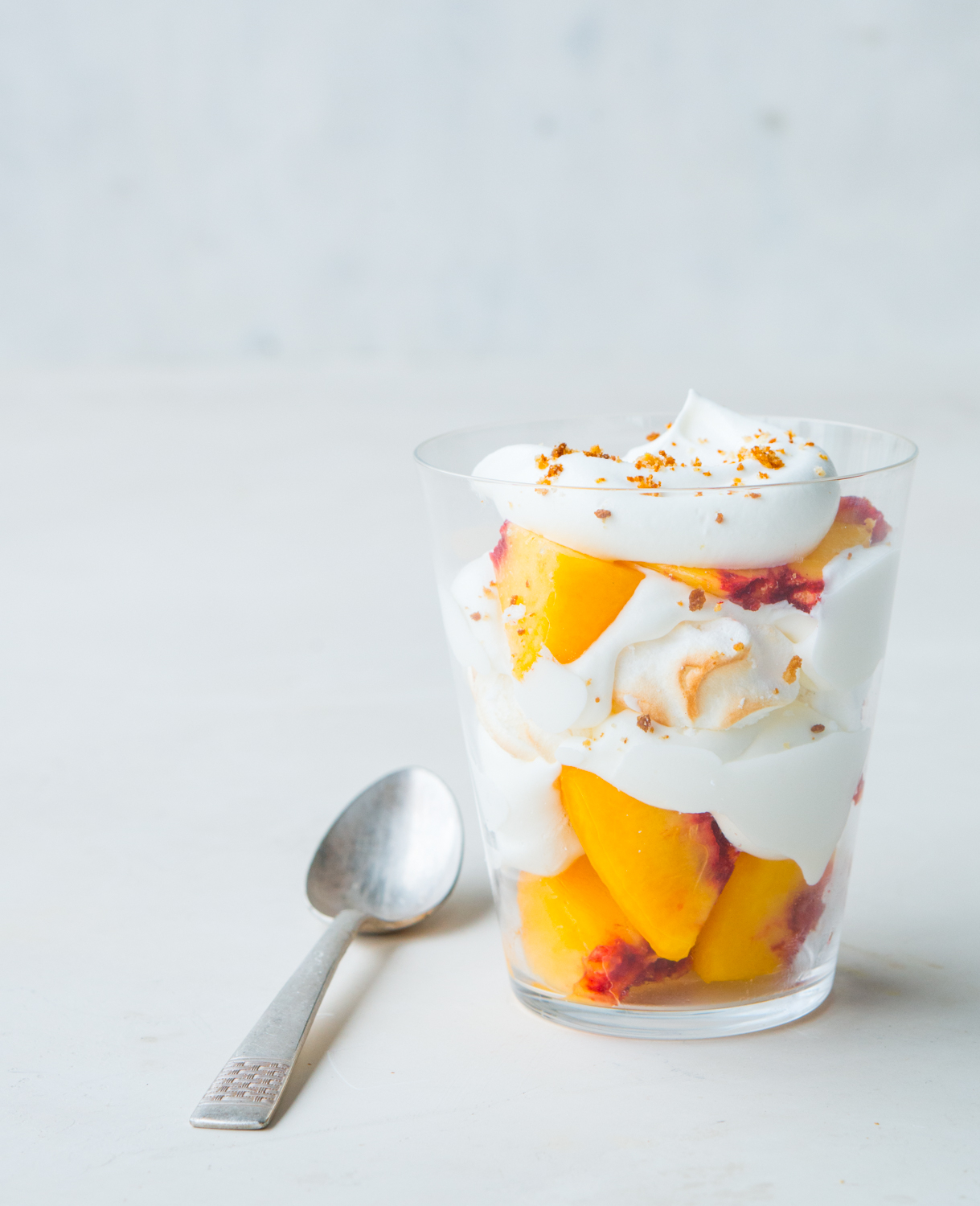 Clear cup of sliced fruit and cream