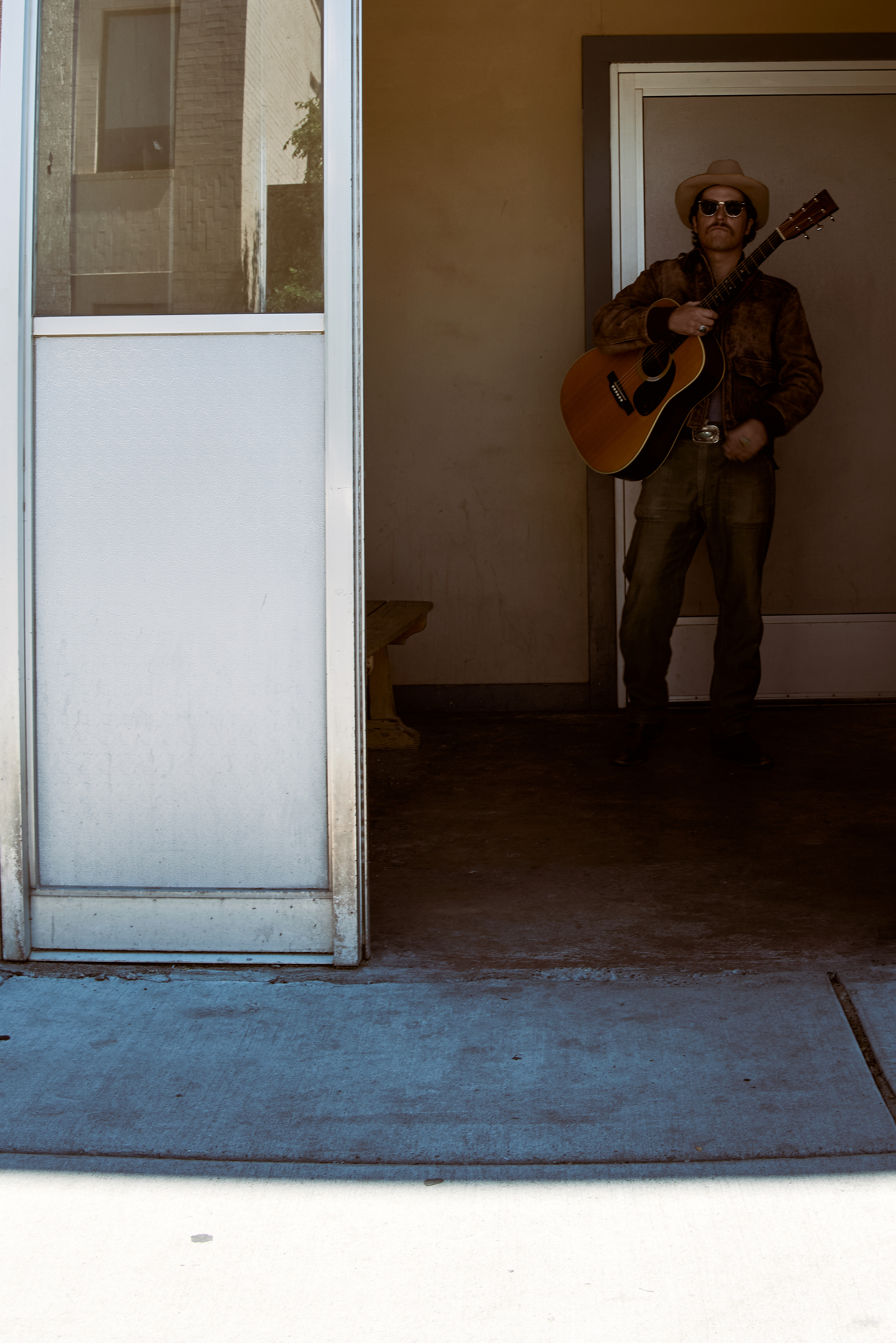 young man plays guitar on the street 