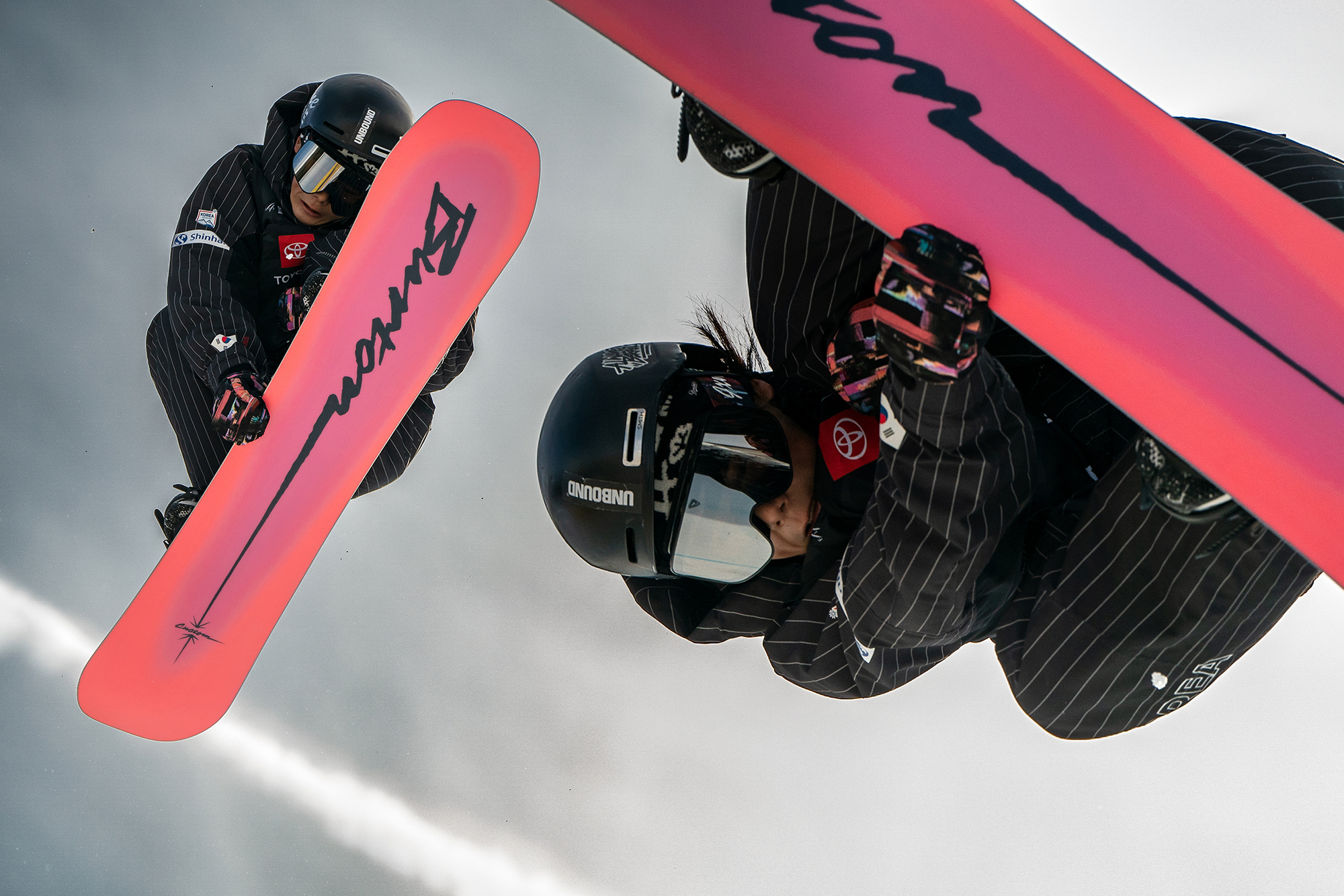 composite of snowboarder flipping over the camera 